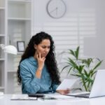 Hispanic businesswoman focusing on work in a home office setup