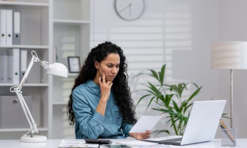 Hispanic businesswoman focusing on work in a home office setup